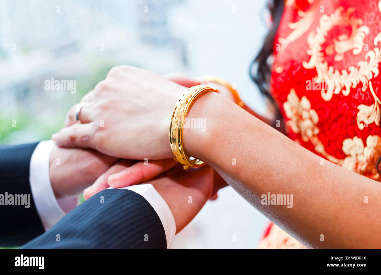 Bride and groom wear wedding rings Stock Photo Alamy