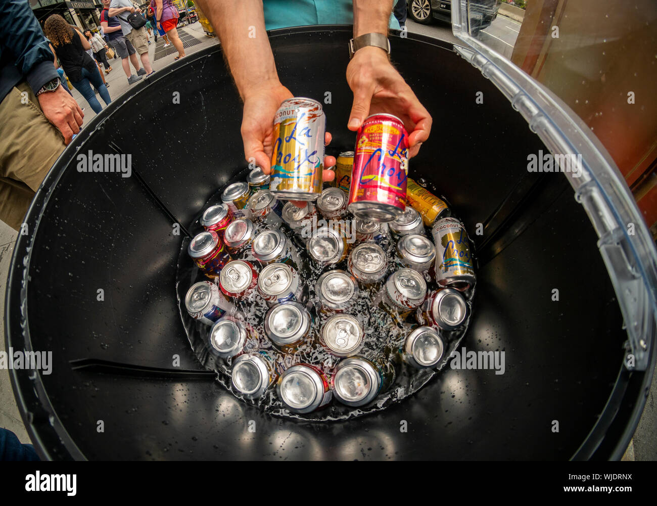 Workers distribute free cans of LaCroix sparkling water’s new flavors at a branding event in the Flatiron neighborhood of New York on Friday, August 23, 2019. Once the darling of millennials, sales of National Beverage Corp.’s LaCroix have fallen precipitously as they face increased competition from “Big Soda”, i.e. Pepsi and Coca-Cola coming out with similar brands. (© Richard B. Levine) Stock Photo