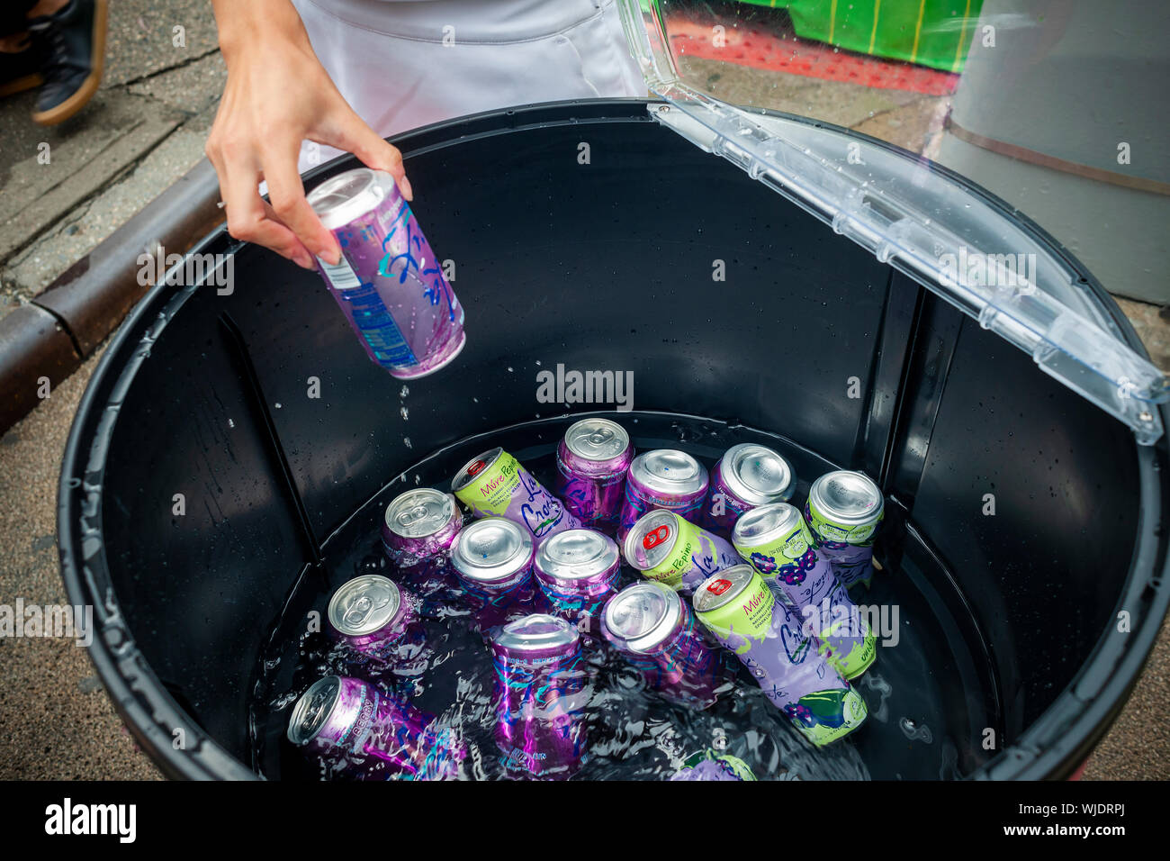 Workers distribute free cans of LaCroix sparkling water’s new flavors at a branding event in the Flatiron neighborhood of New York on Friday, August 23, 2019. Once the darling of millennials, sales of National Beverage Corp.’s LaCroix have fallen precipitously as they face increased competition from “Big Soda”, i.e. Pepsi and Coca-Cola coming out with similar brands. (© Richard B. Levine) Stock Photo