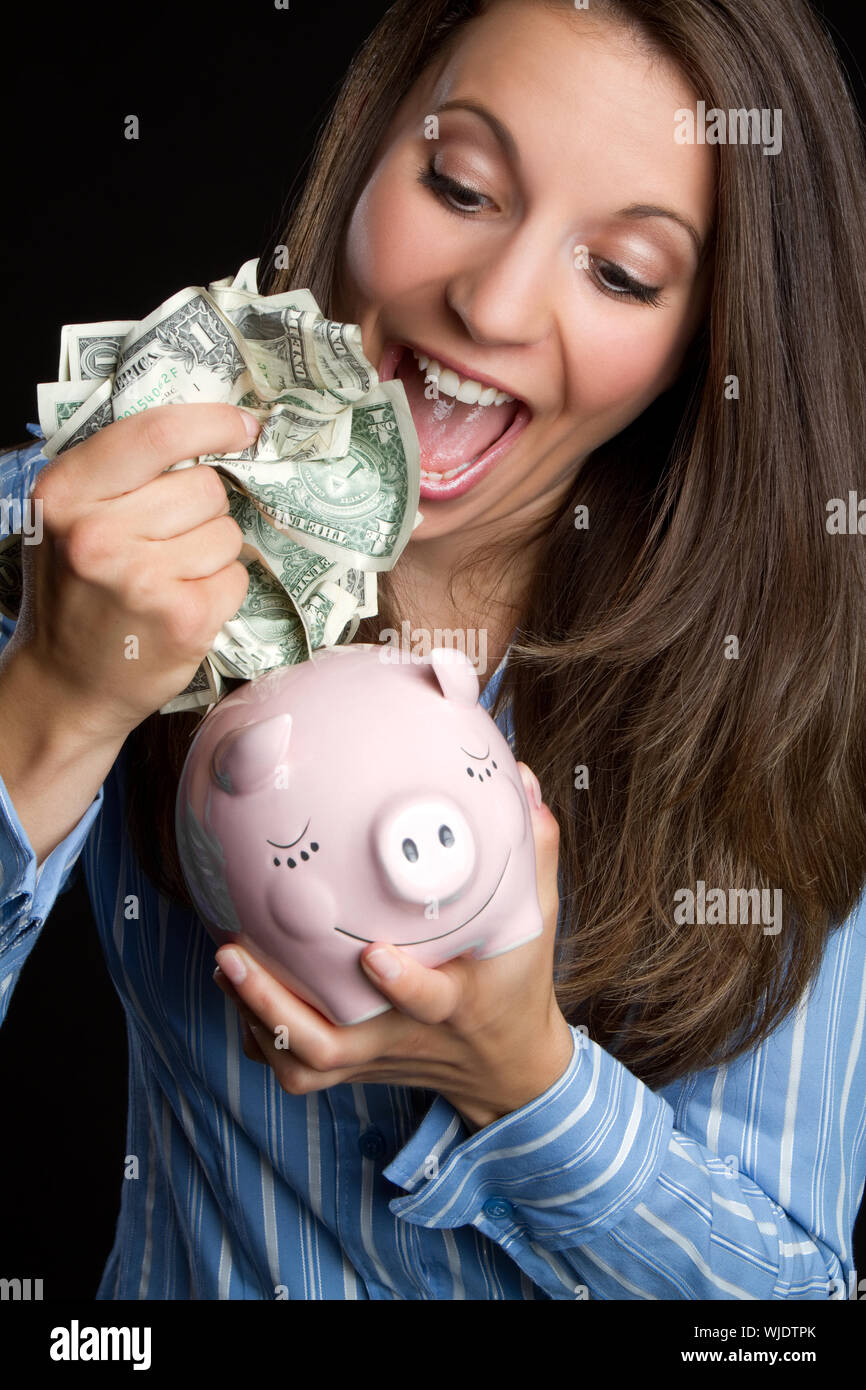 Woman saving money in piggy bank Stock Photo - Alamy