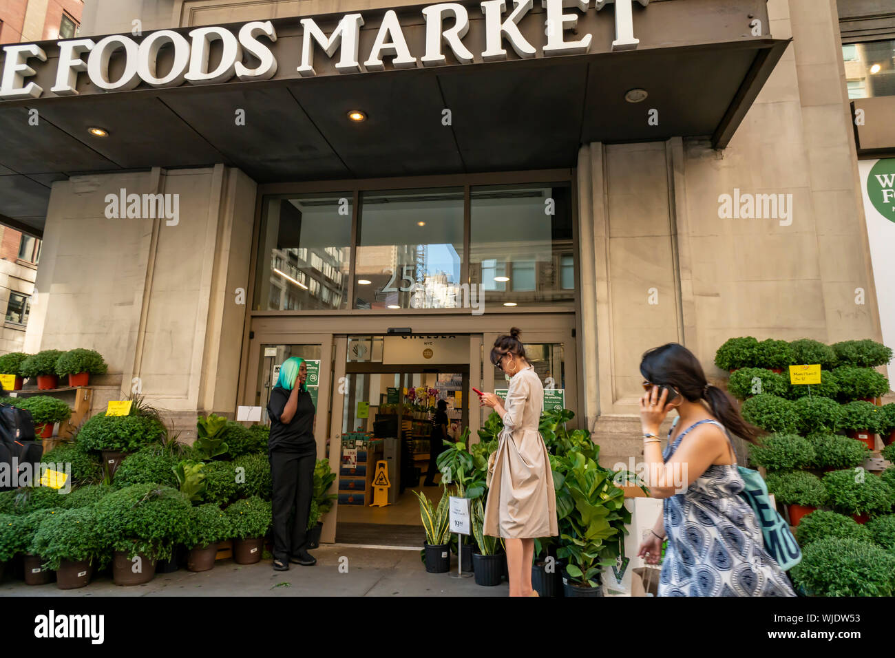 Shoppers outside of Whole Foods Market in the Chelsea neighborhood of New York on Thursday, August 22, 2019 (© Richard B. Levine) Stock Photo