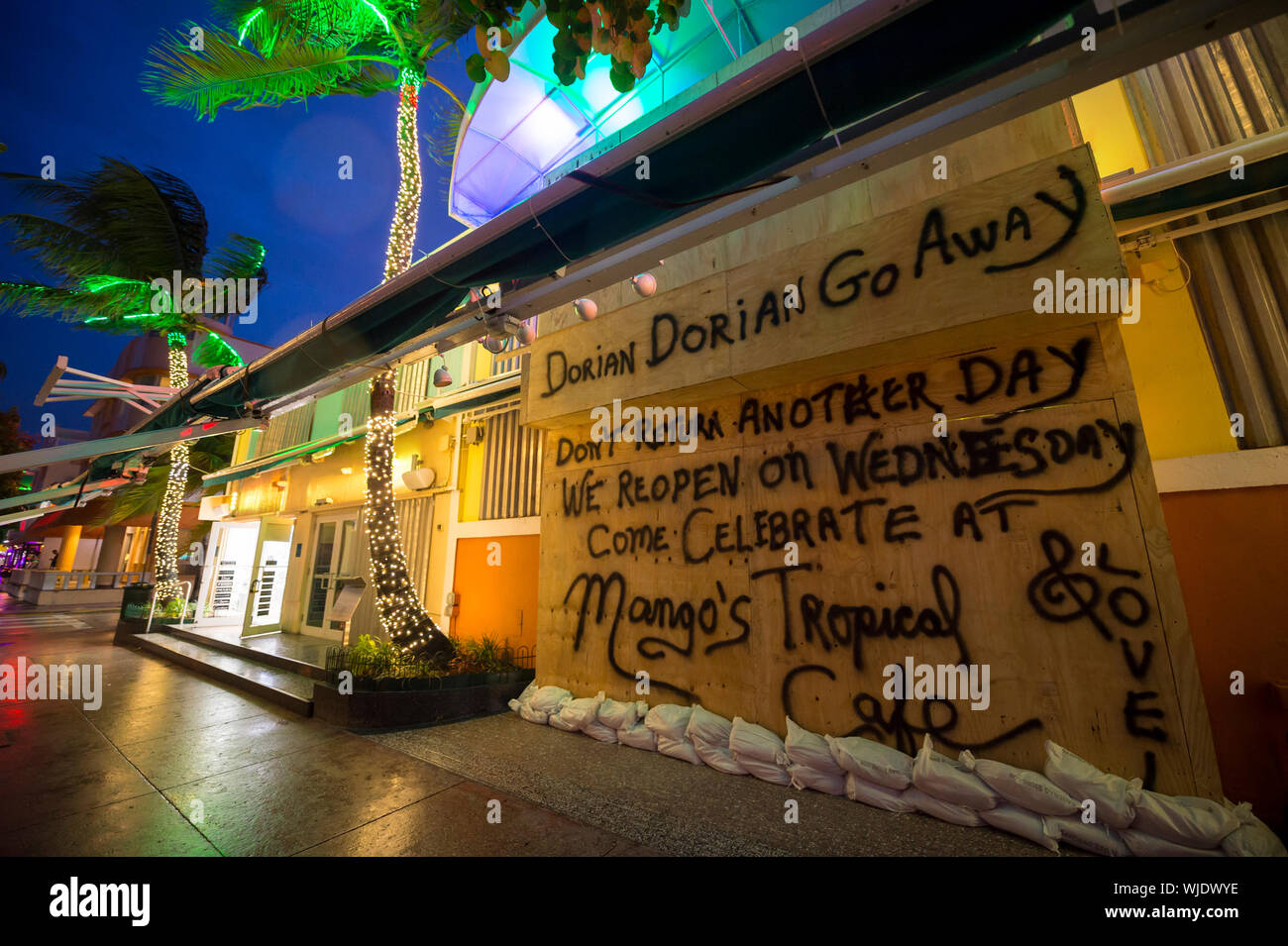 MIAMI - SEPTEMBER 02, 2019: Signs on Mango's nightblub on Ocean Drive, boarded up for Hurricane Dorian, inform Labor Day visitors of reopening plans. Stock Photo