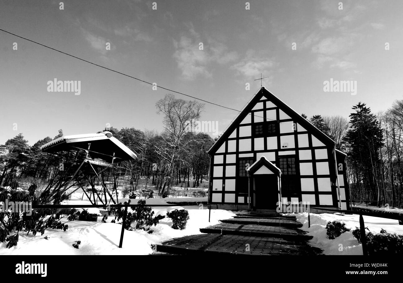 Lubno, Poland: small half-timbered church, parish of the king Christ, winter, black and white photography Stock Photo