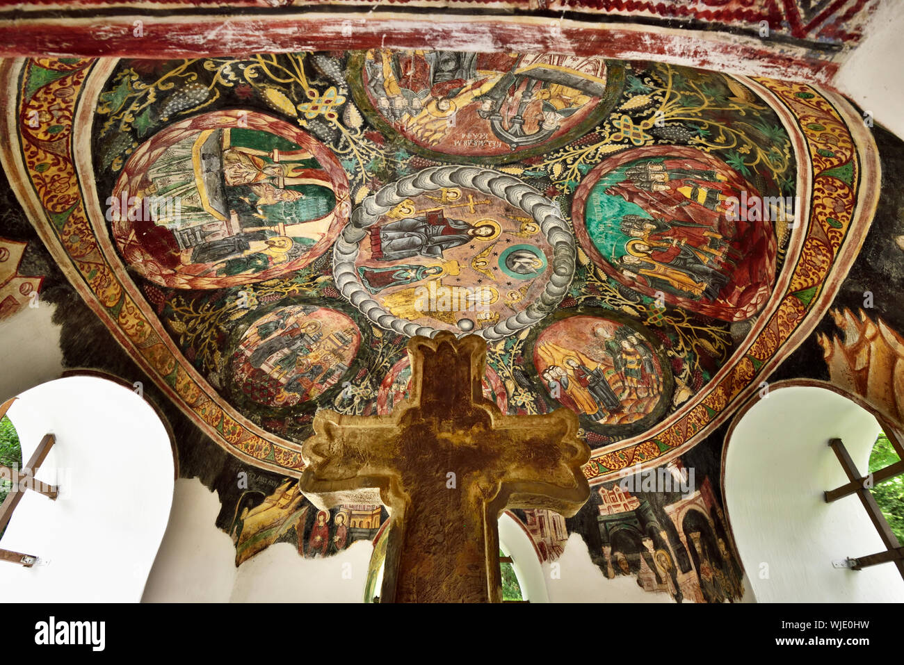 Painted Crucifix with brick shelter. Rasinari, Sibiu county. ASTRA Museum of Traditional Folk Civilization, an open-air museum outside Sibiu, Transylv Stock Photo