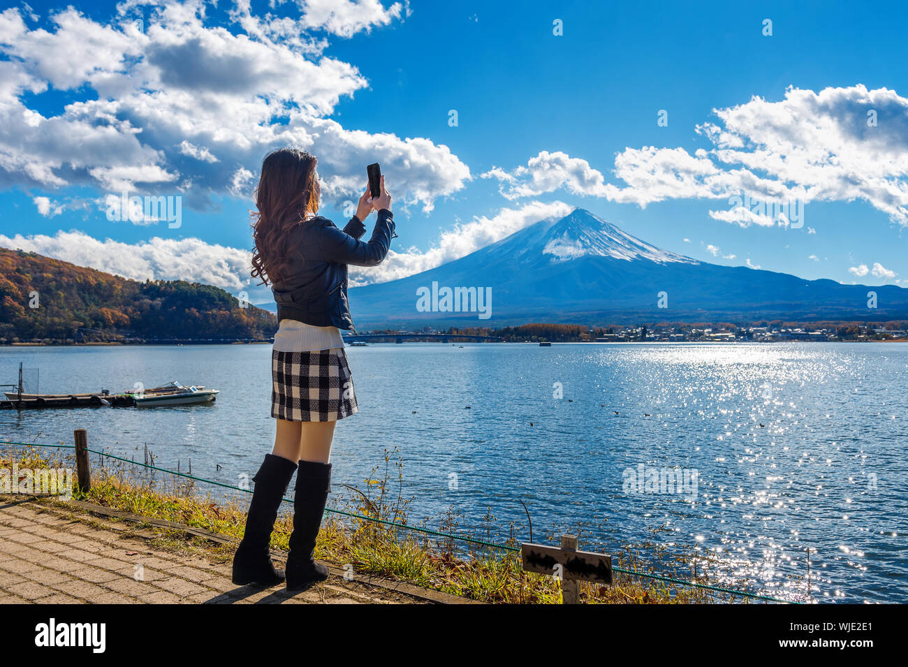 Full Length Of Woman By Lake Kawaguchi Photographing Mt Fuji Stock Photo