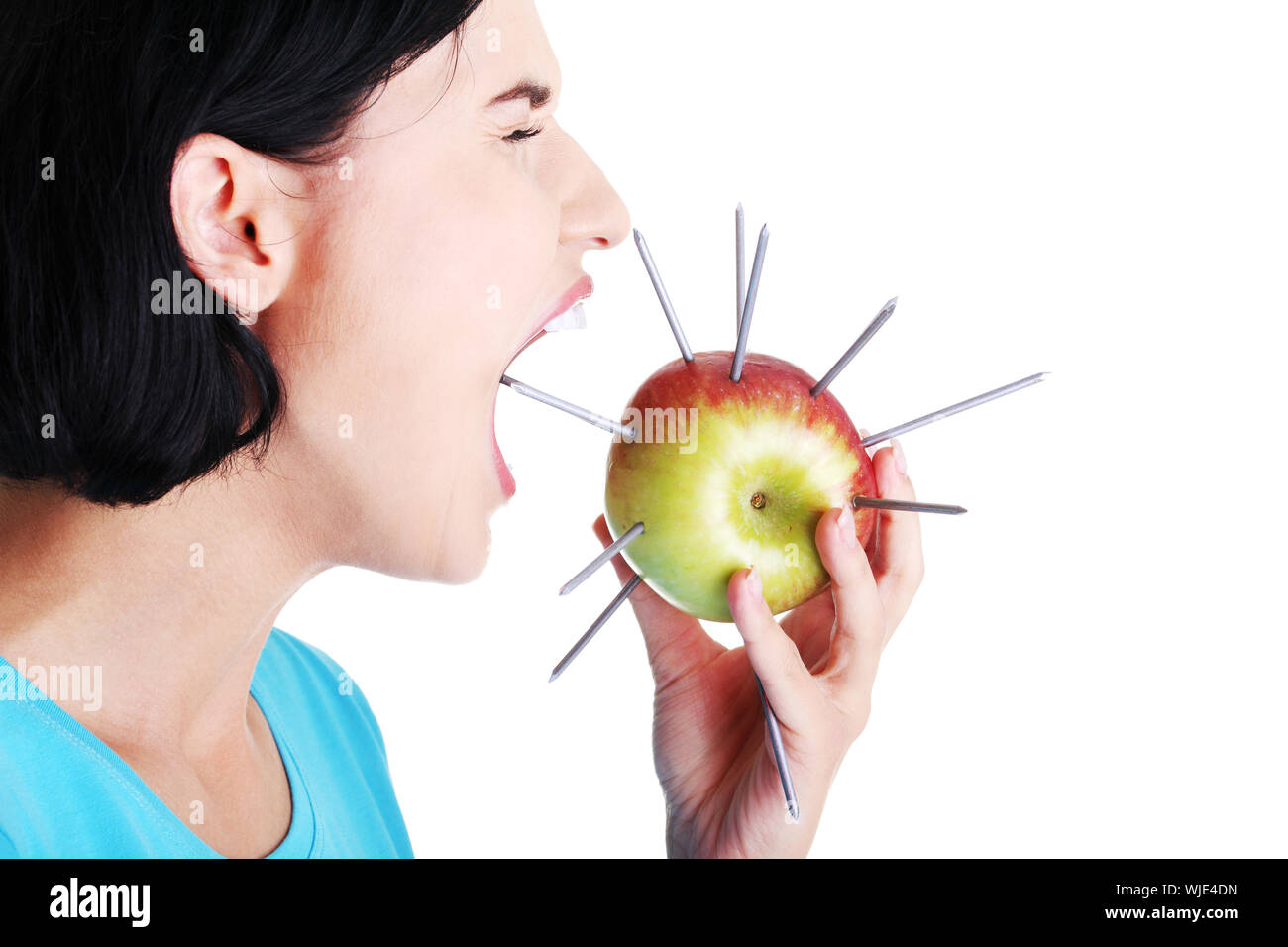 Throat pain concept. Woman eating apple with nails Stock Photo Alamy