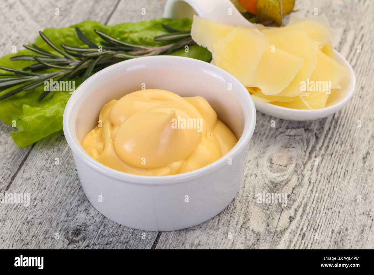 Cheese sauce in the bowl served sliced parmesan Stock Photo Alamy