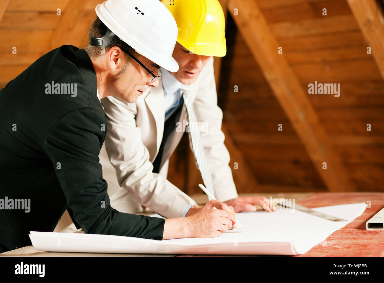 Architect and construction engineer discussing plan Stock Photo