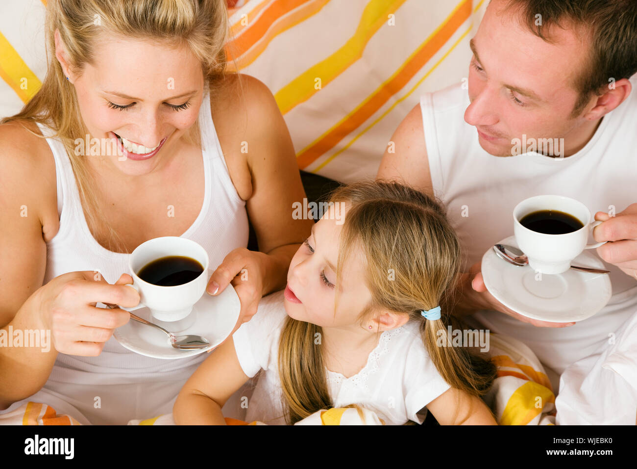 Family breakfasting in bed Stock Photo