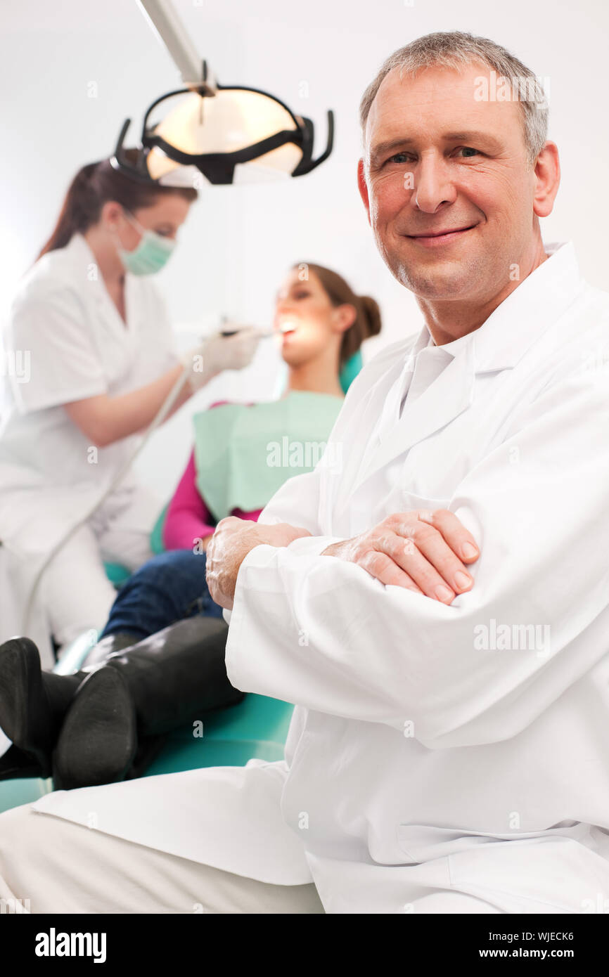 Dentist in his surgery Stock Photo Alamy
