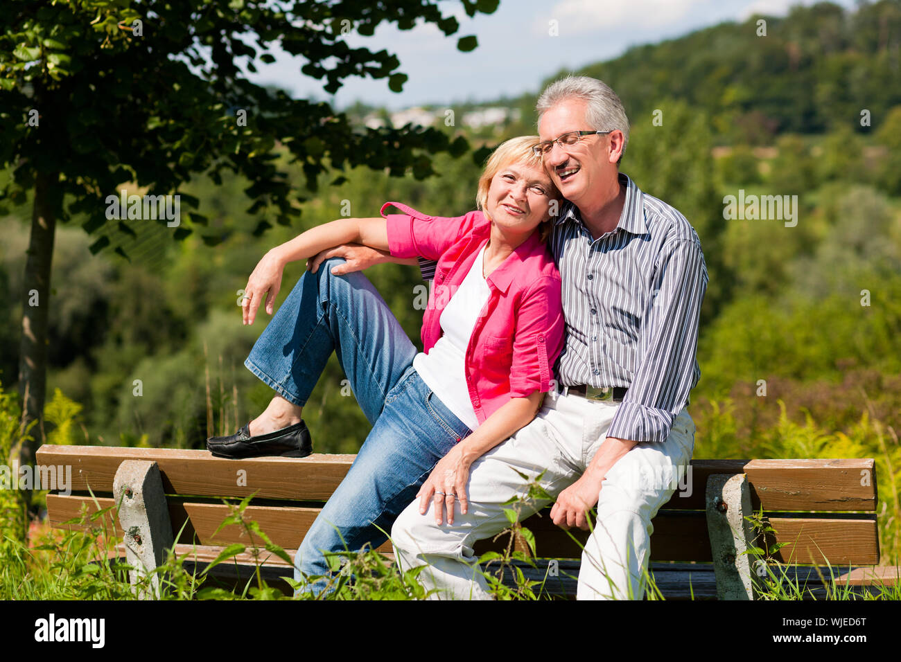 Senior couple sitting on bench Stock Photo