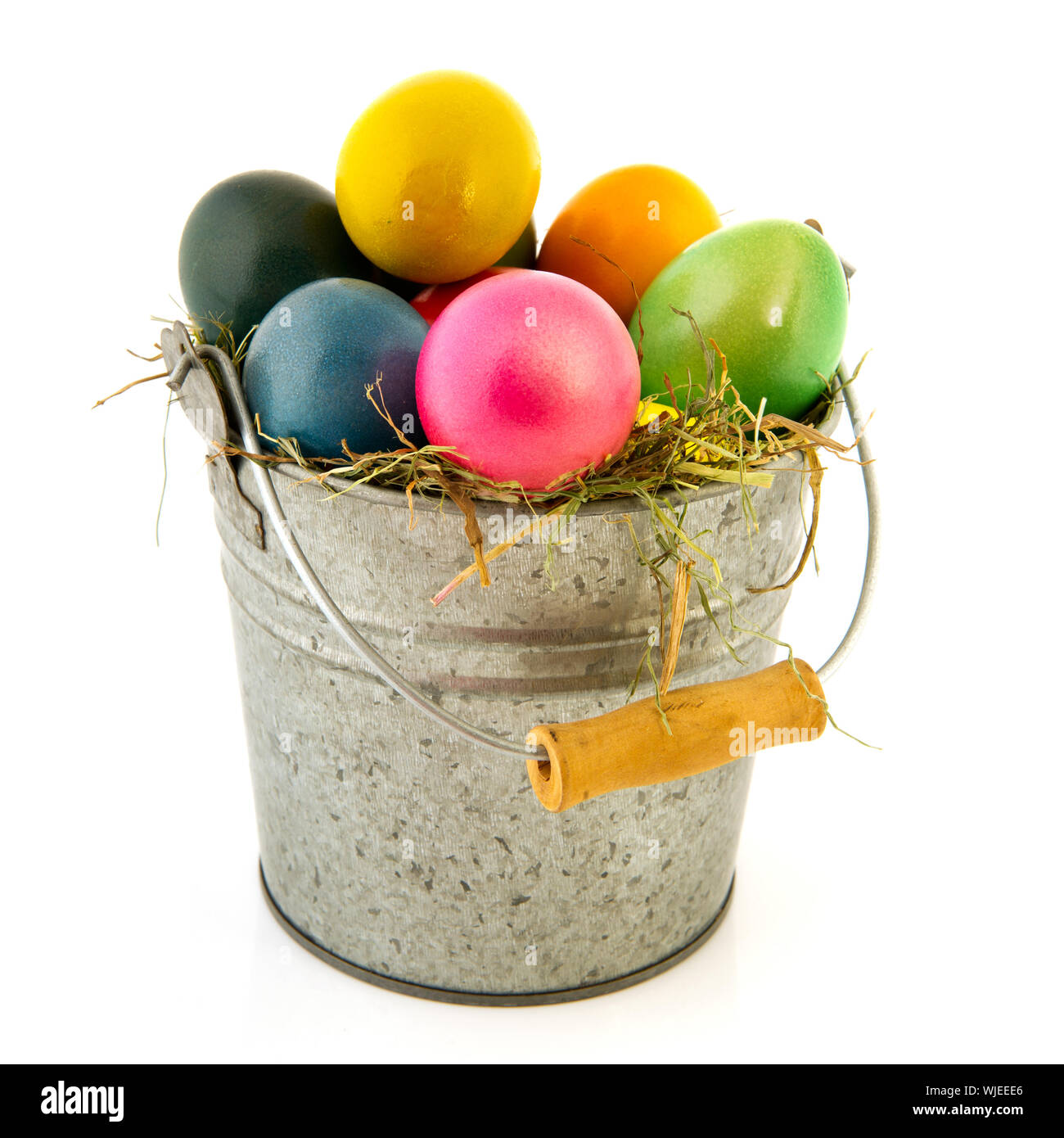 Bucket colorful easter eggs isolated over white background Stock Photo ...