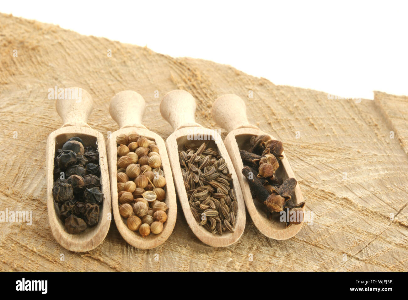 four spices, pepper, coriander, cloves and caraway seed Stock Photo Alamy