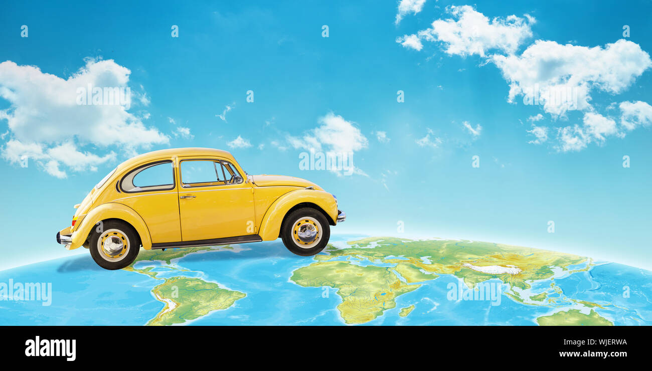 Yellow car on globe concept. Sky in background. Stock Photo