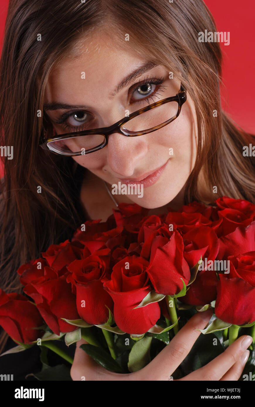 Beautiful woman with bouquet of roses Stock Photo