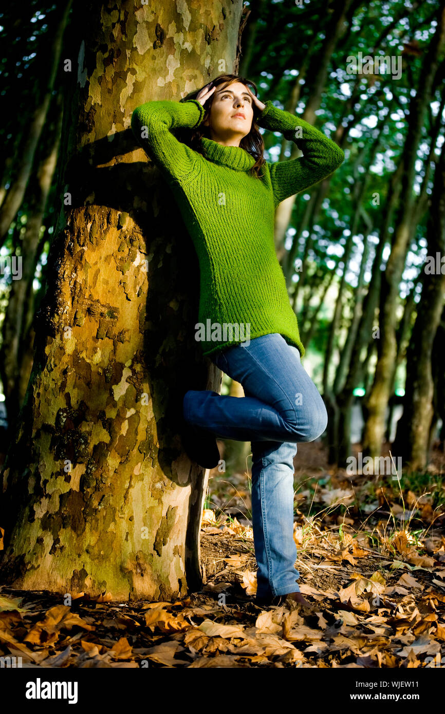 Autumn portrait of a beautiful young woman close to a tree Stock Photo ...
