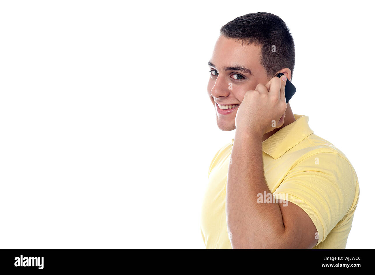 Young handsome guy attending a phone call Stock Photo