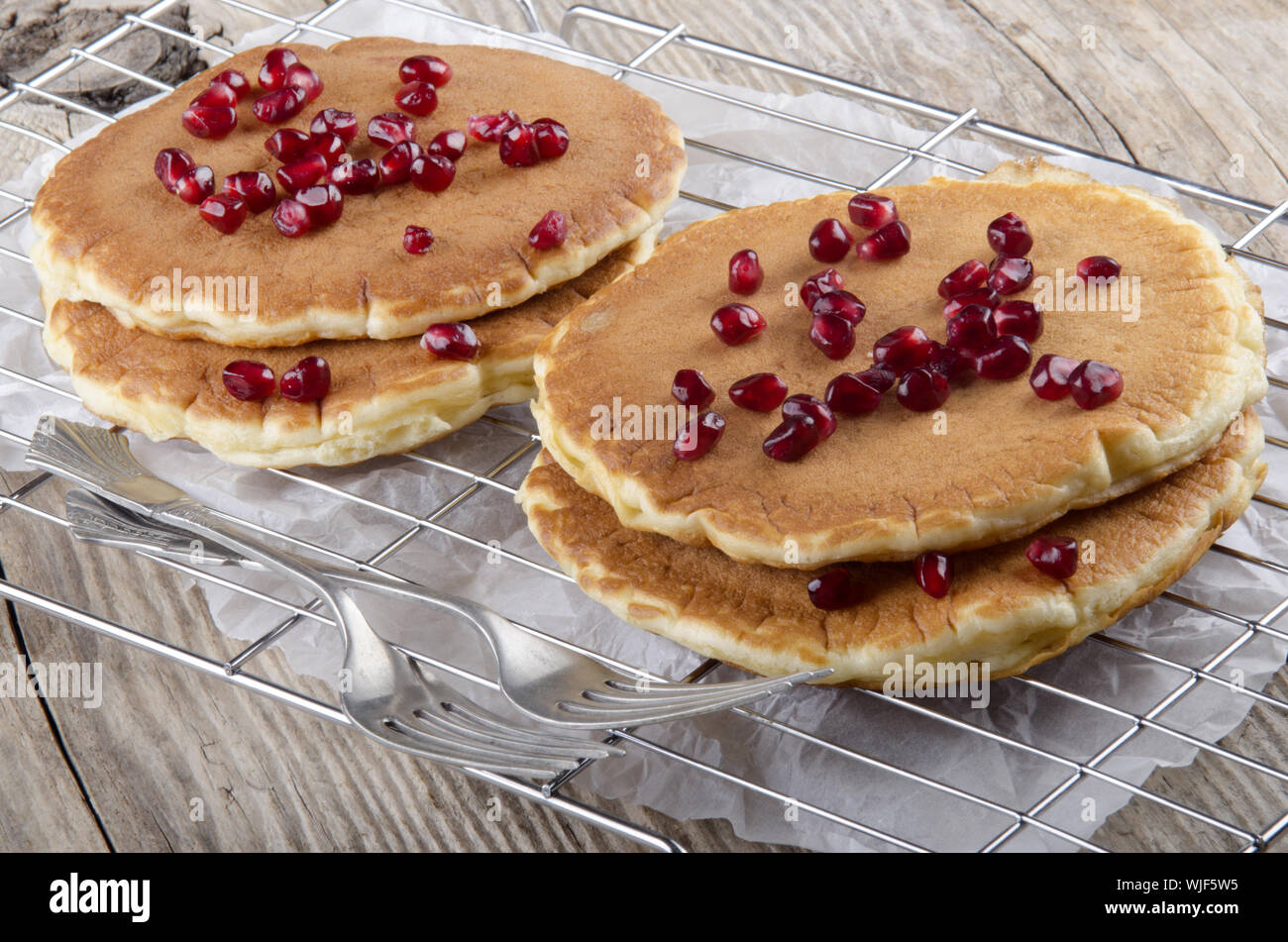 home made pancake with pomegranate seed on a cooling rack Stock Photo ...