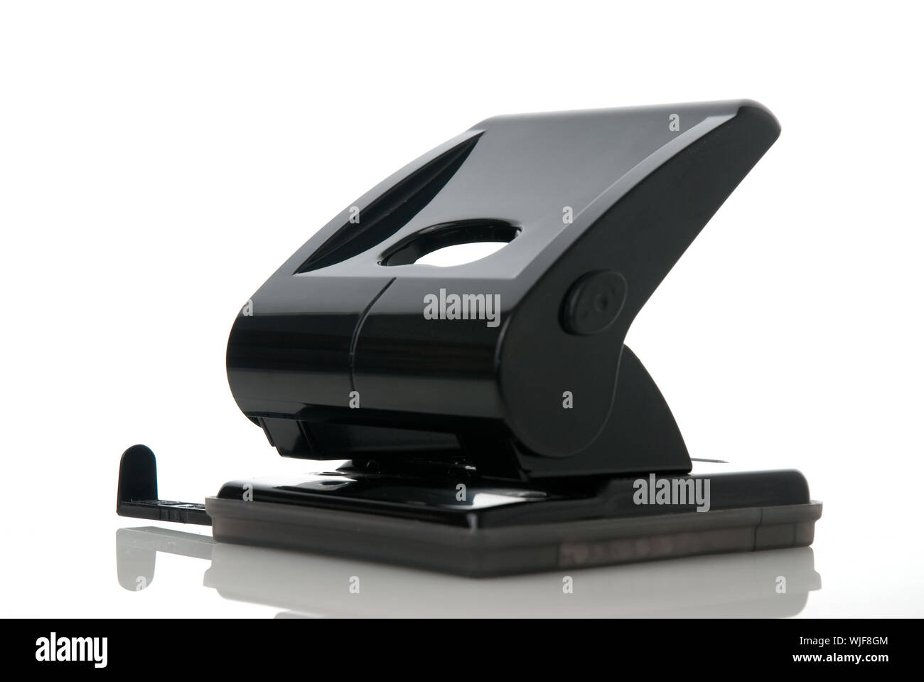 Black paper hole puncher, office tool equipment that is used to create  holes in sheets of paper, isolated on a white background, with clipping  path Stock Photo