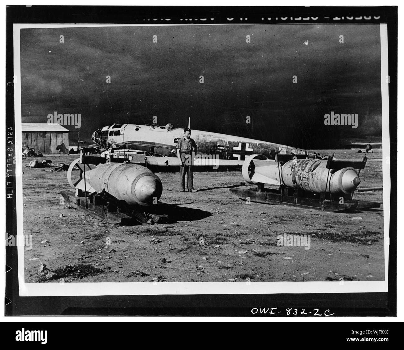 Vicinity of Neghazi, Libya. When the United Nations air forces attacked this airfield they forced the Nazis to abandon much equipment and ammunition. In the foreground are two heavy bombs. Note the sleds which were used to move them around the airfield. Stock Photo