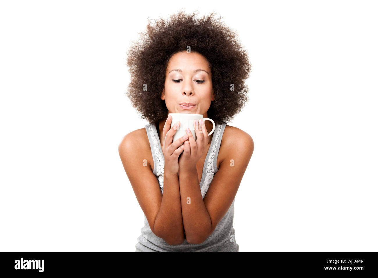 Beautiful young woman holding a cup of coffee, isolated on white Stock ...