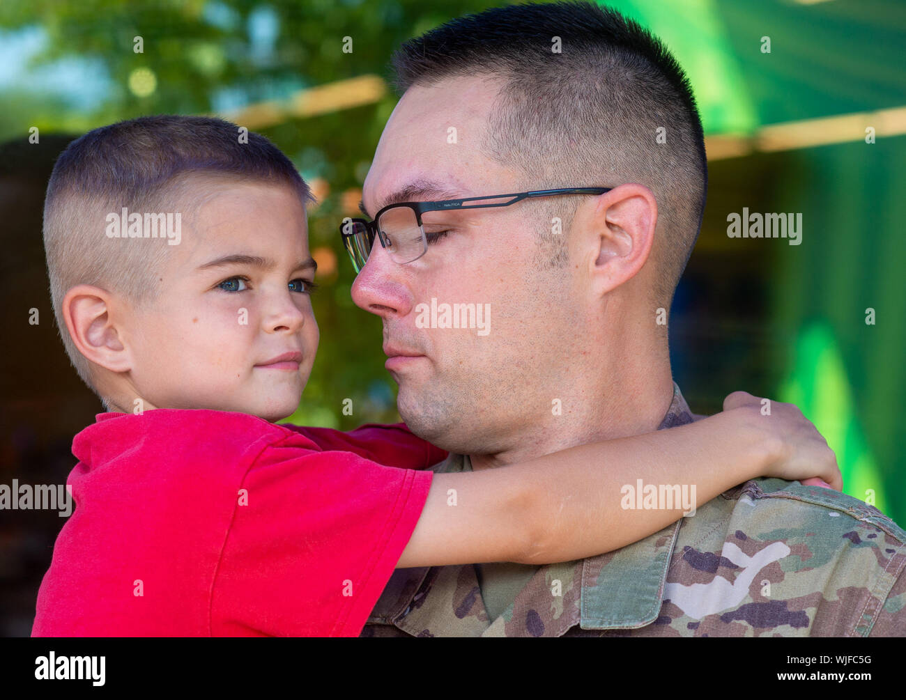 Master Sergeant William Davis hugs Joshua, 6, during his surprise return from overseas deployment Sunday, August 04, 2019 at Sesame Place in Langhorne Stock Photo
