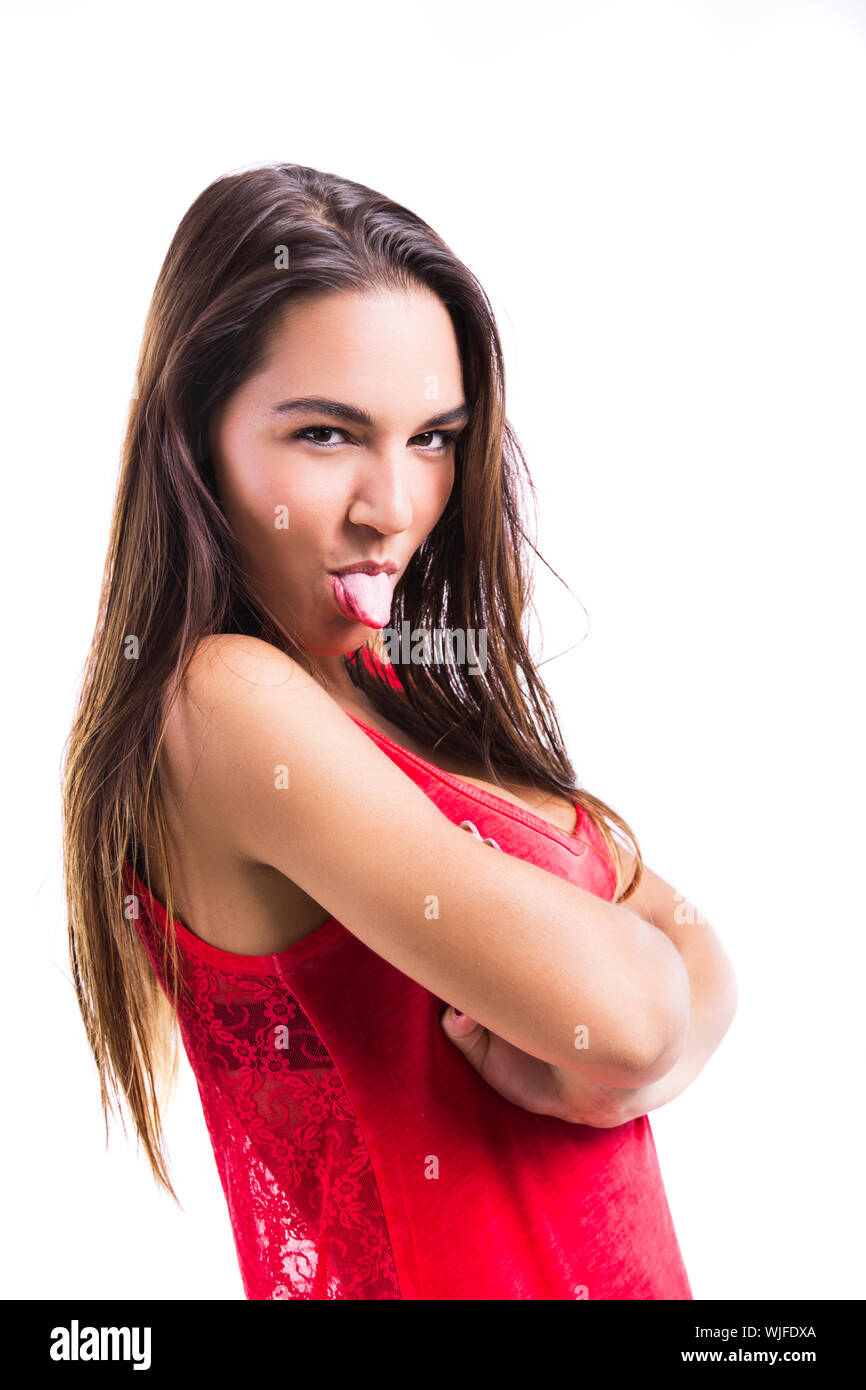 Beautiful young woman making  a grimace with her tongue off, isolated over a white background Stock Photo