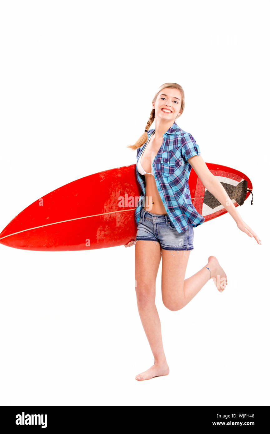 Beautiful young woman with a surfboard, over a gray background Stock Photo