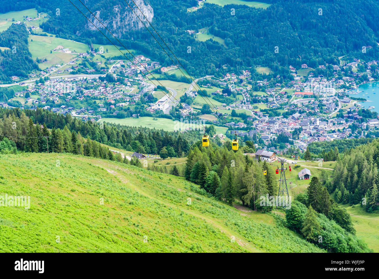 View of St.Gilgen village and colorful Seilbahn cable car gondolas from ...