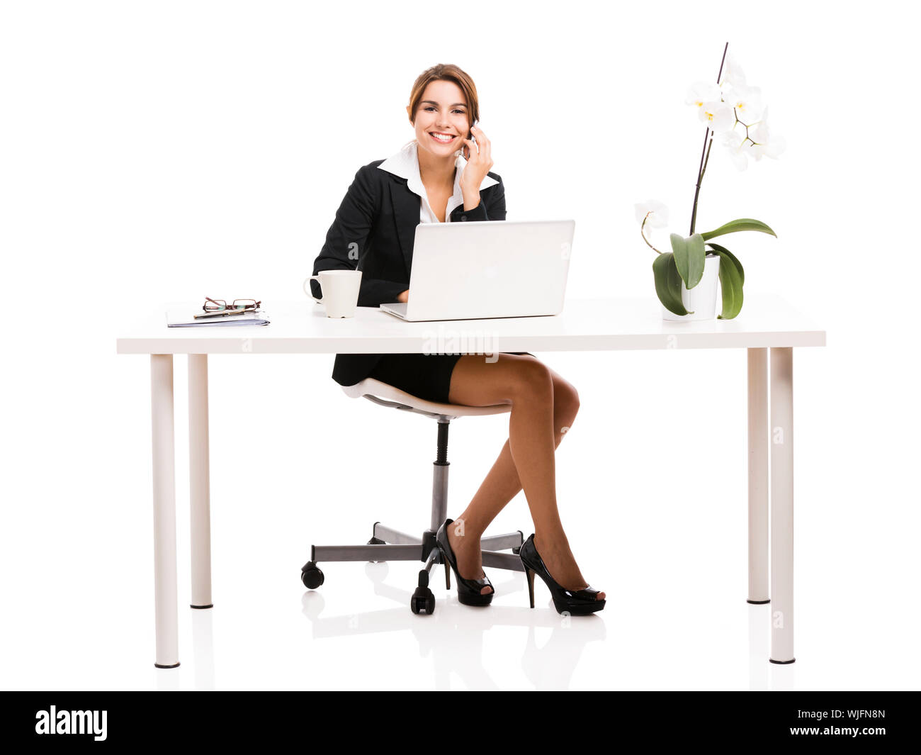 Beautiful hispanic business woman working in the office, isolated over a white background Stock Photo