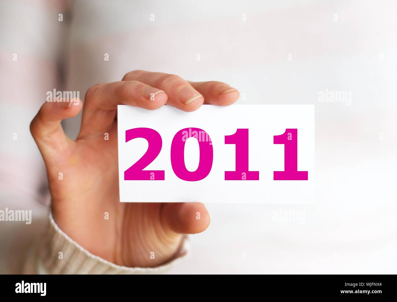hand holding 2011 showing happy new year concept Stock Photo - Alamy