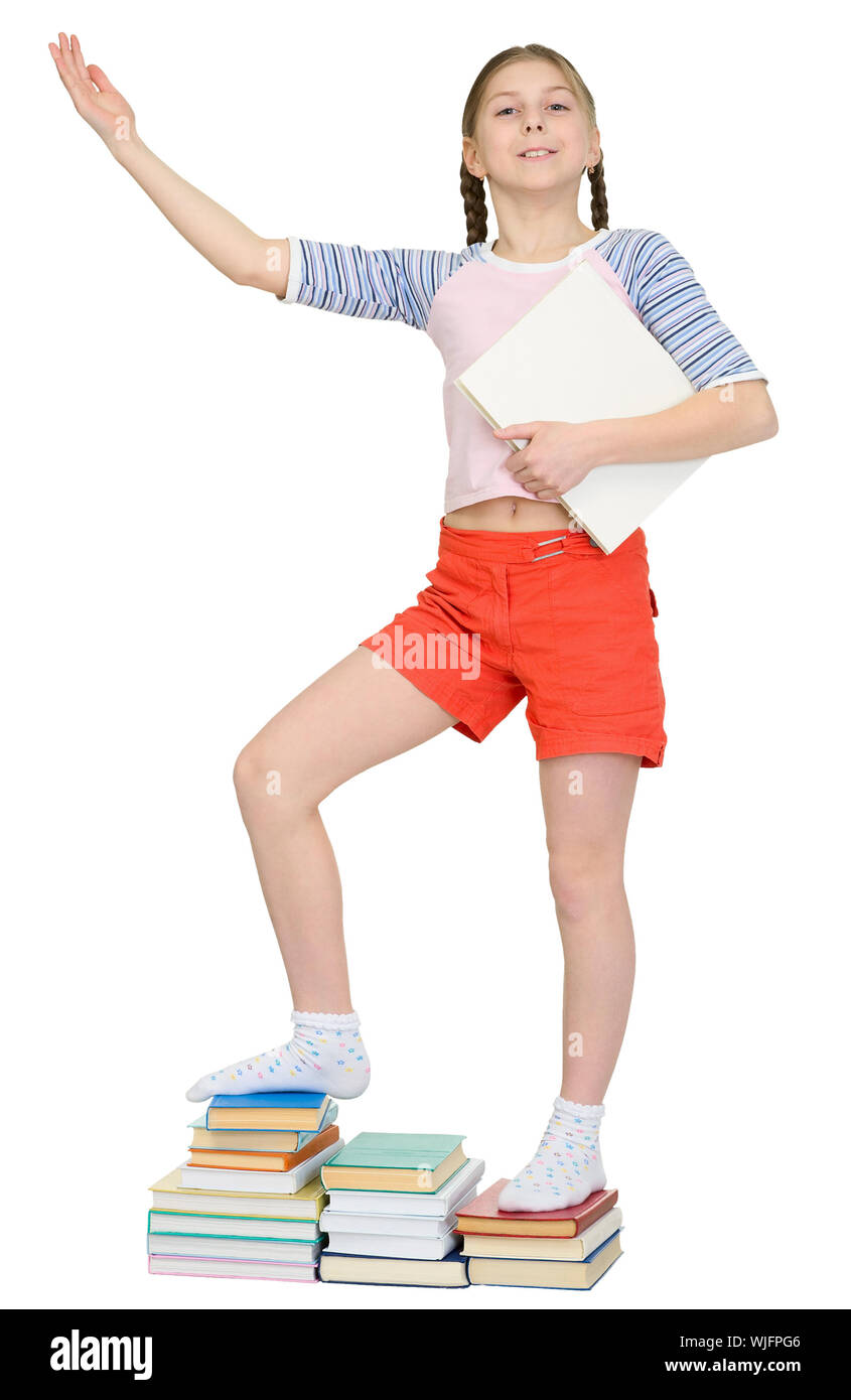 Girl standing on piles of books on a white background Stock Photo - Alamy