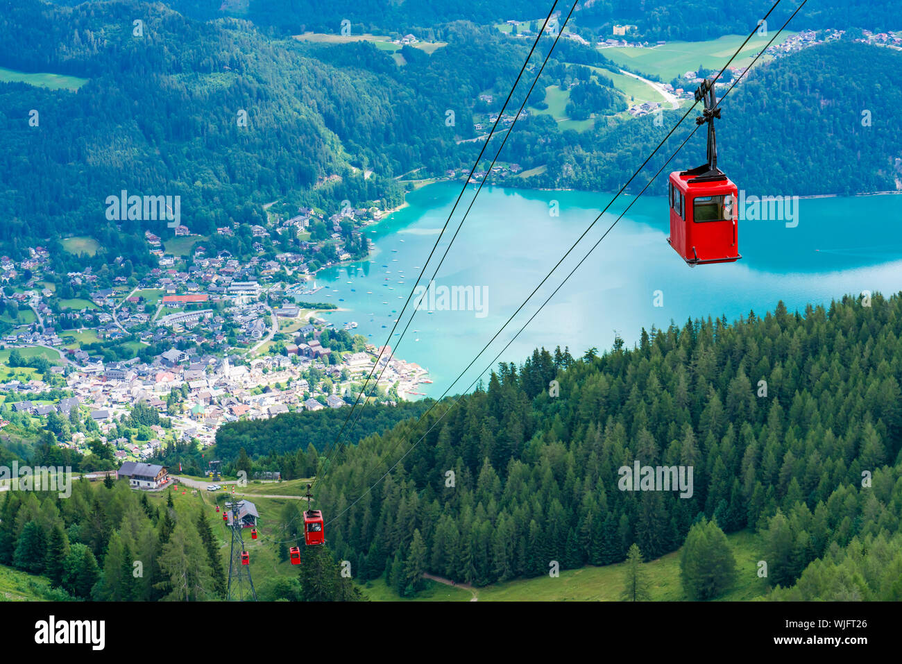 View of St.Gilgen village, Wolfgangsee lake and red Seilbahn cable car ...