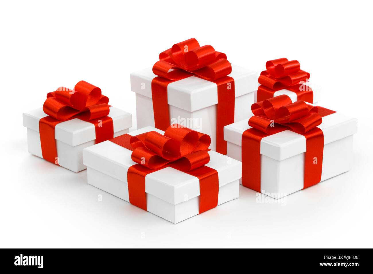 Gift boxes with red ribbon bows on white background Stock Photo - Alamy