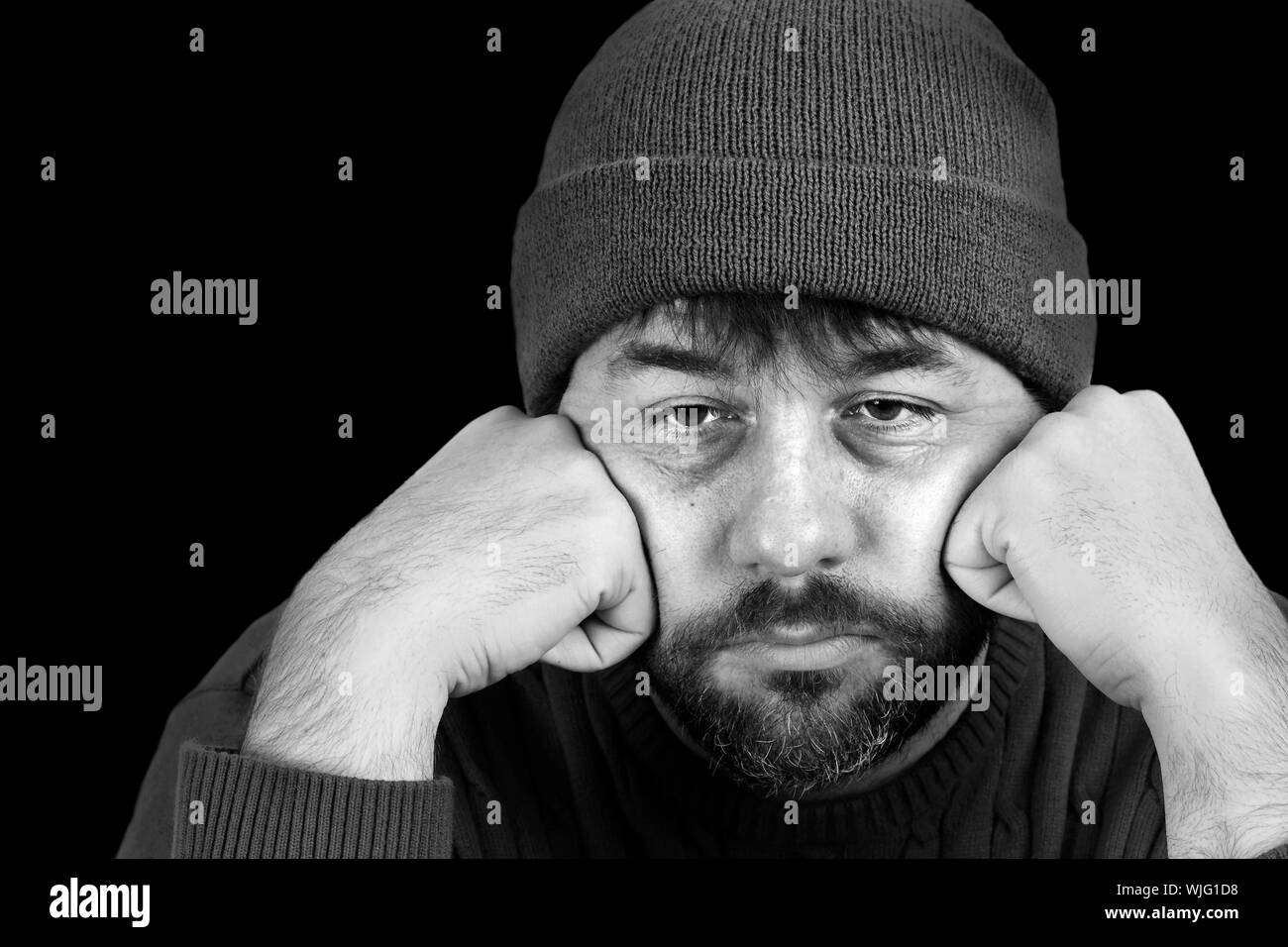 Dramatic black and white portrait of a man in despair Stock Photo