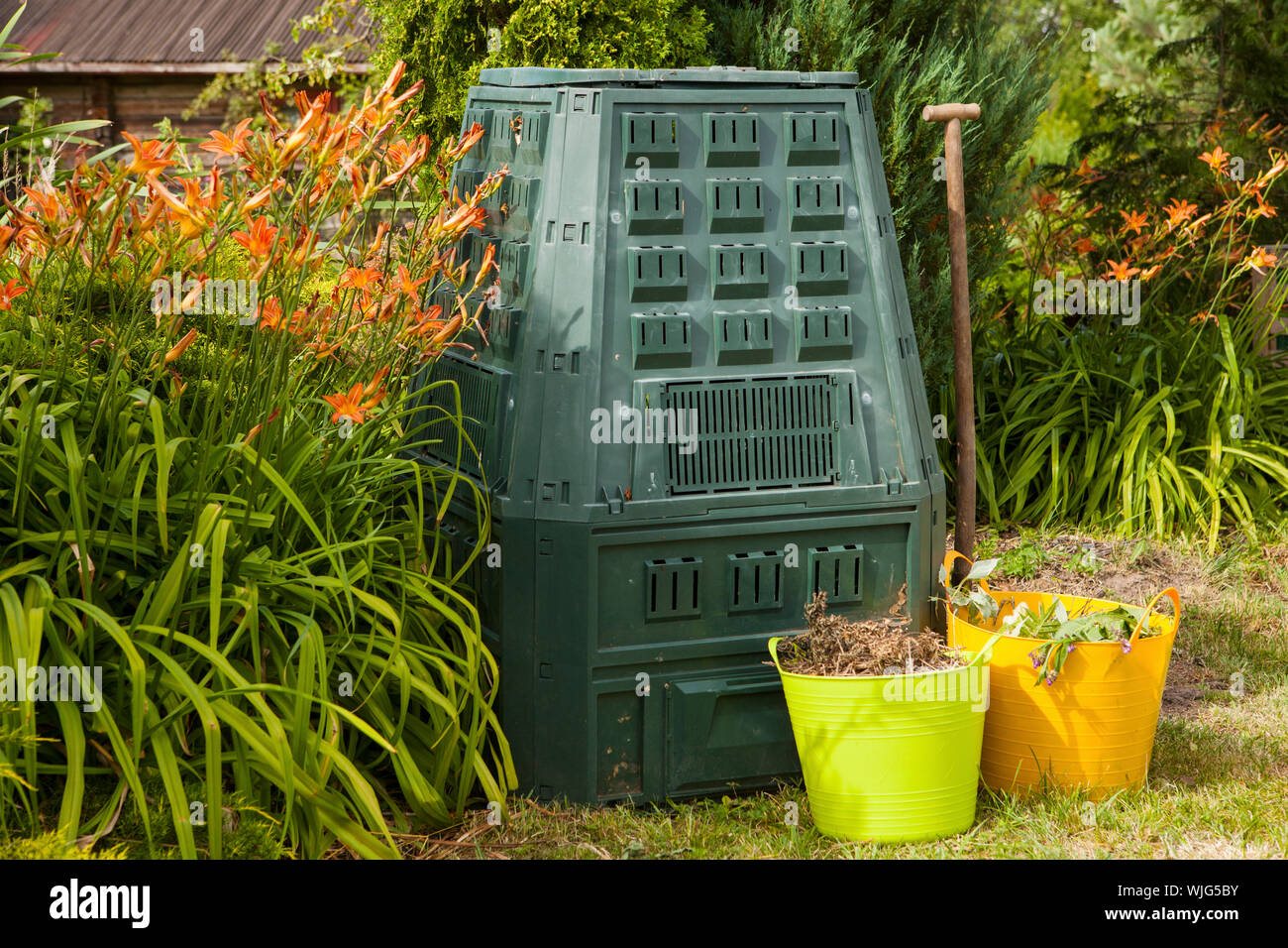 Large backyard wooden garden waste composting bin Stock Photo - Alamy