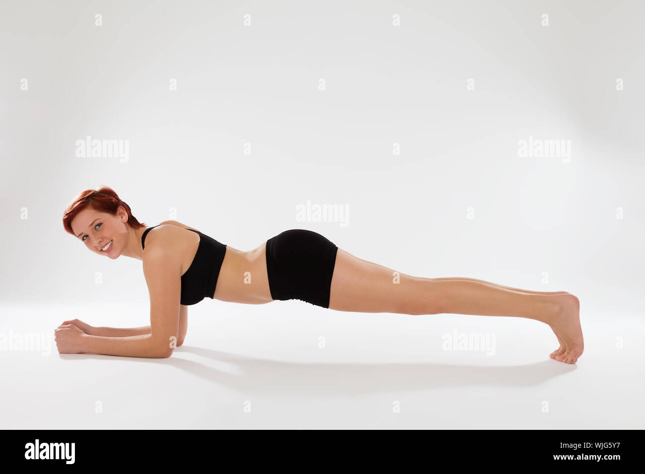 happy fitness woman exercising elbow pushups Stock Photo Alamy