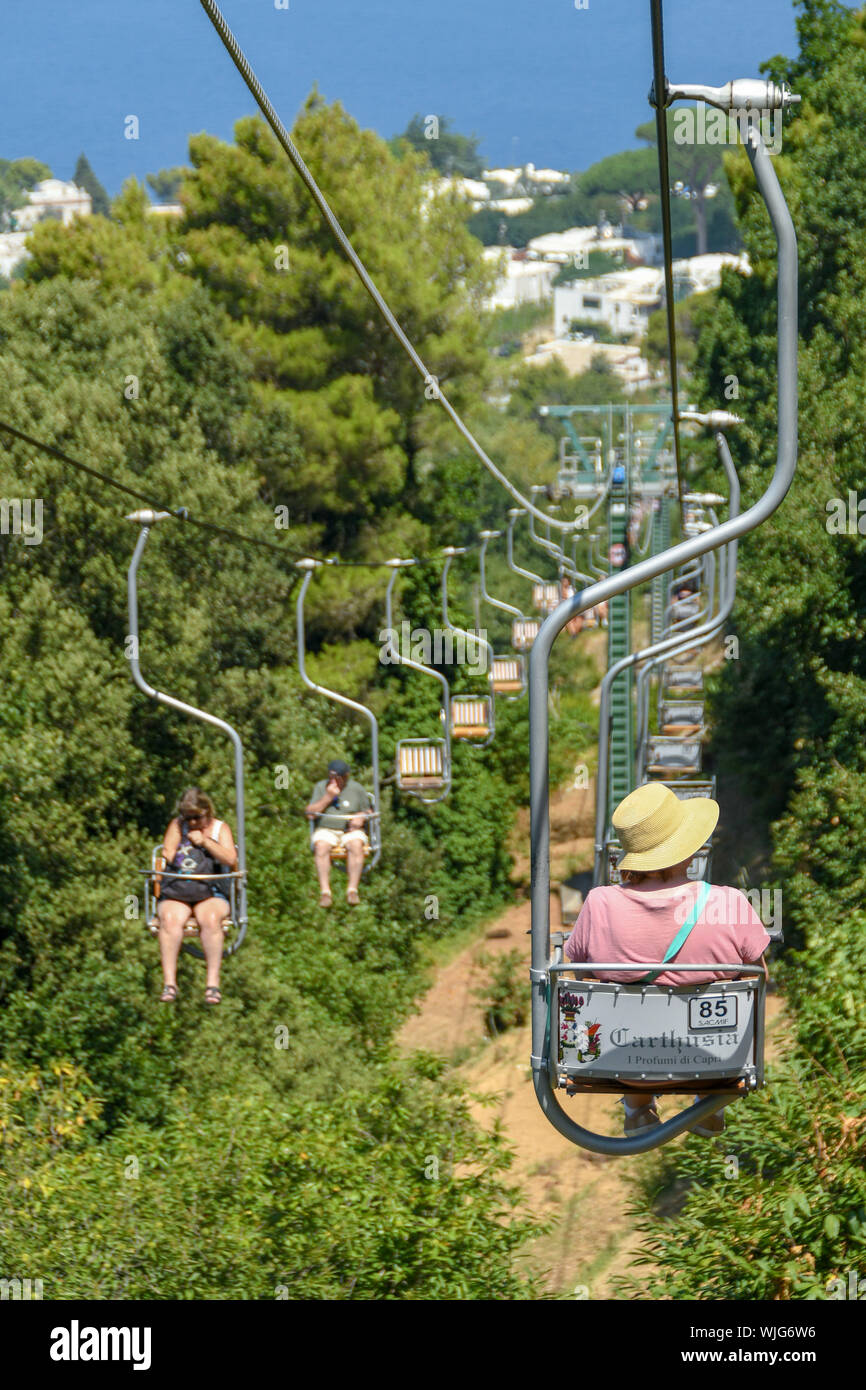ANACAPRI, ISLE OF CAPRI, ITALY - AUGUST 2019: Visitors on a chair lift  travelling up and down to the summit of Mount Solaro above Anacapri Stock  Photo - Alamy