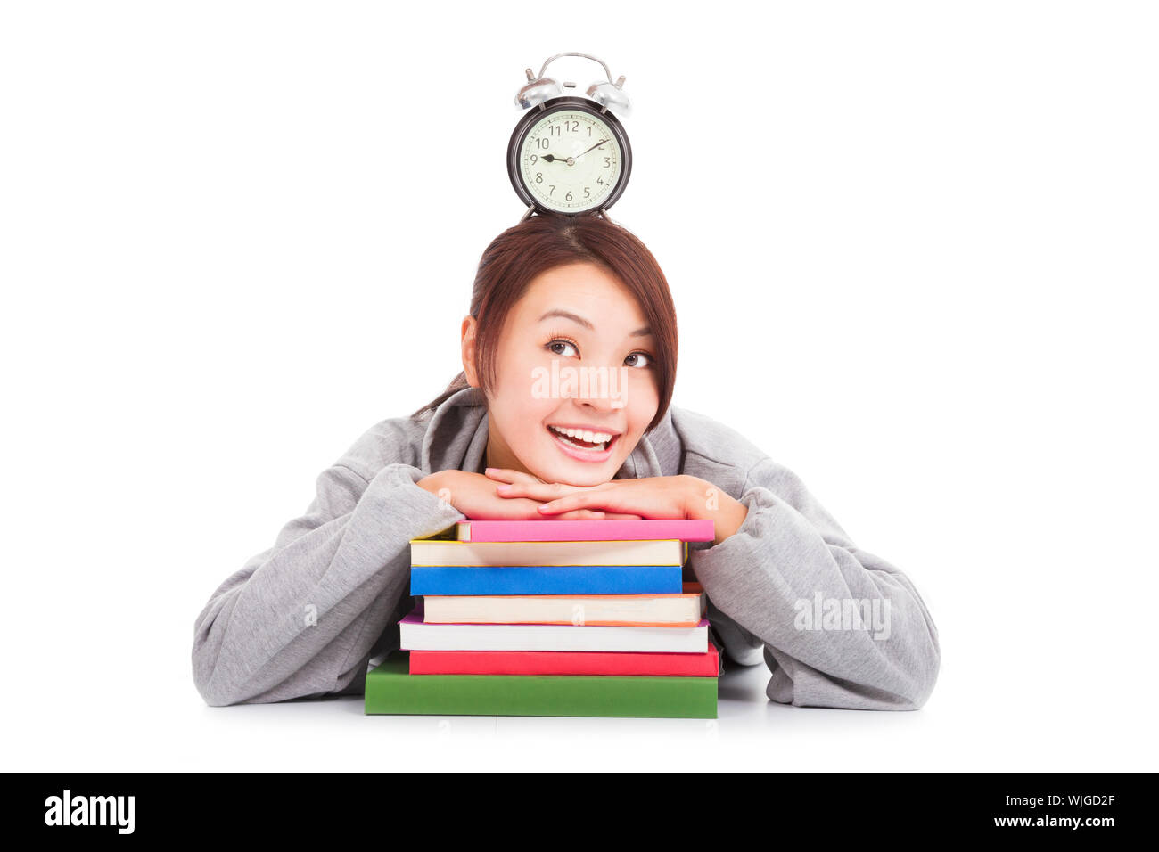 happy young student looking clock with books Stock Photo Alamy