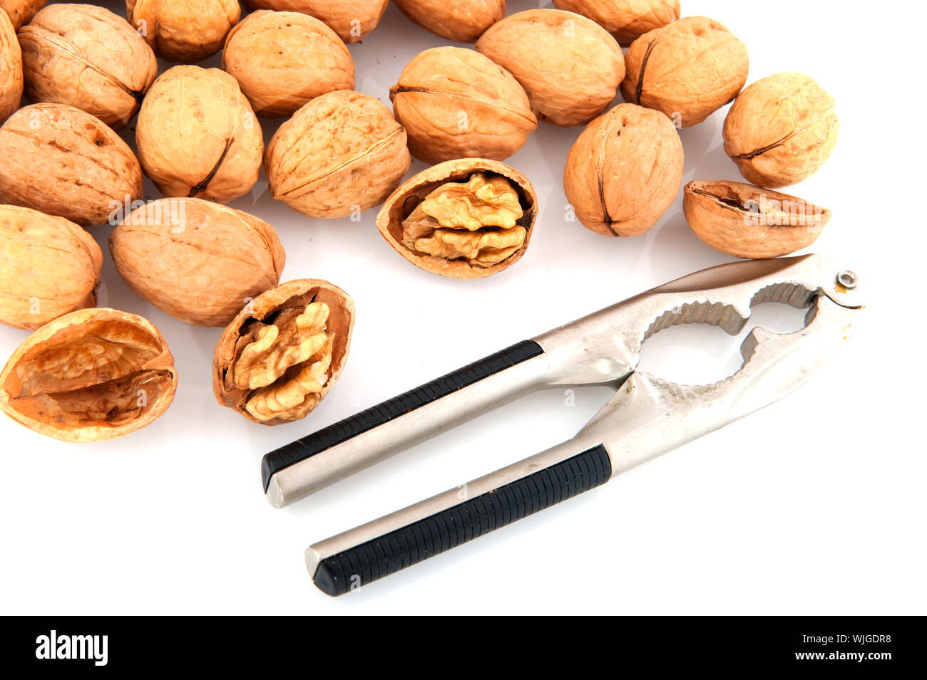 Several open and closed walnuts isolated over white Stock Photo