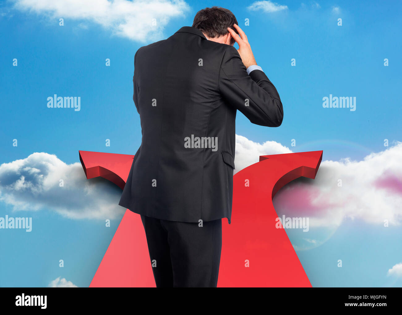 Stressed businessman with hands on head against airplane flying past ...