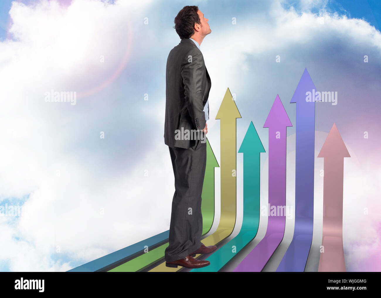 Serious businessman with hand on hip against airplane flying past ...