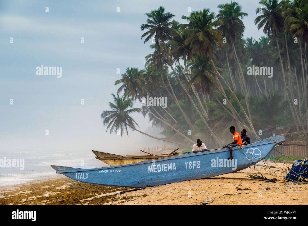 Fisherman on a fishing boat at the beach of rural fishing village ...