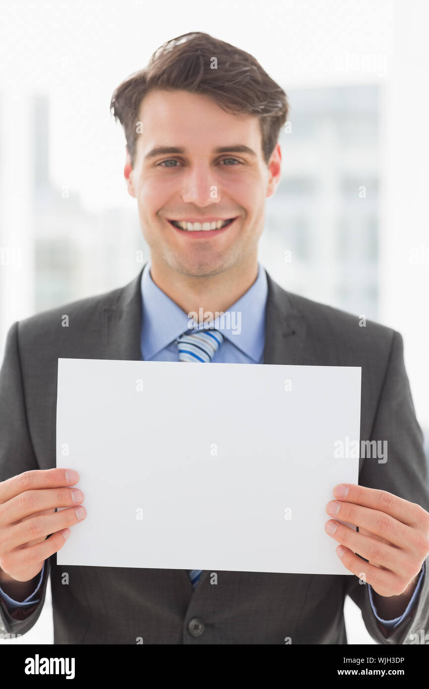 Happy businessman holding blank page in the office Stock Photo Alamy
