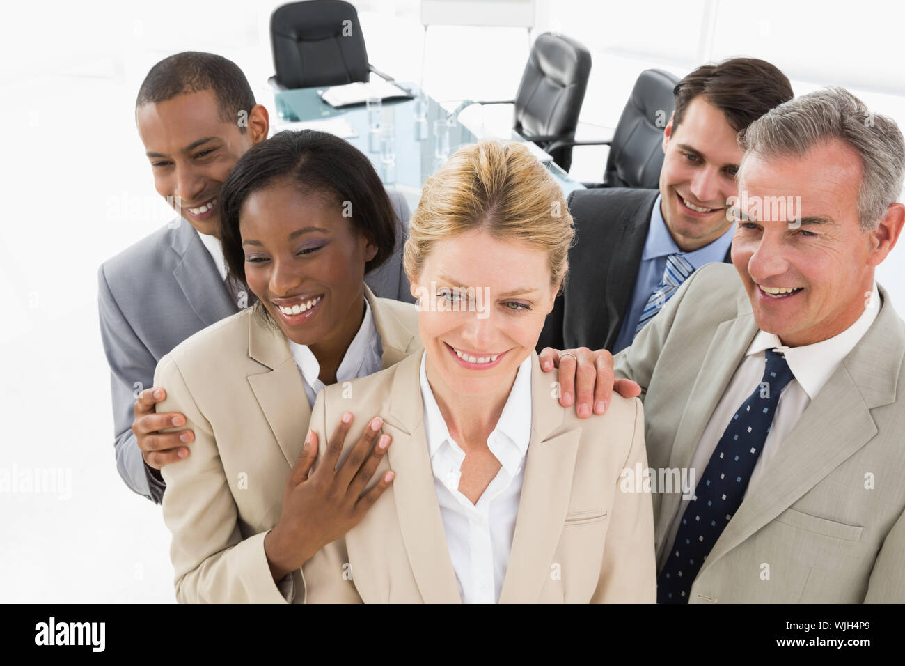 Diverse close business team smiling in the office Stock Photo - Alamy