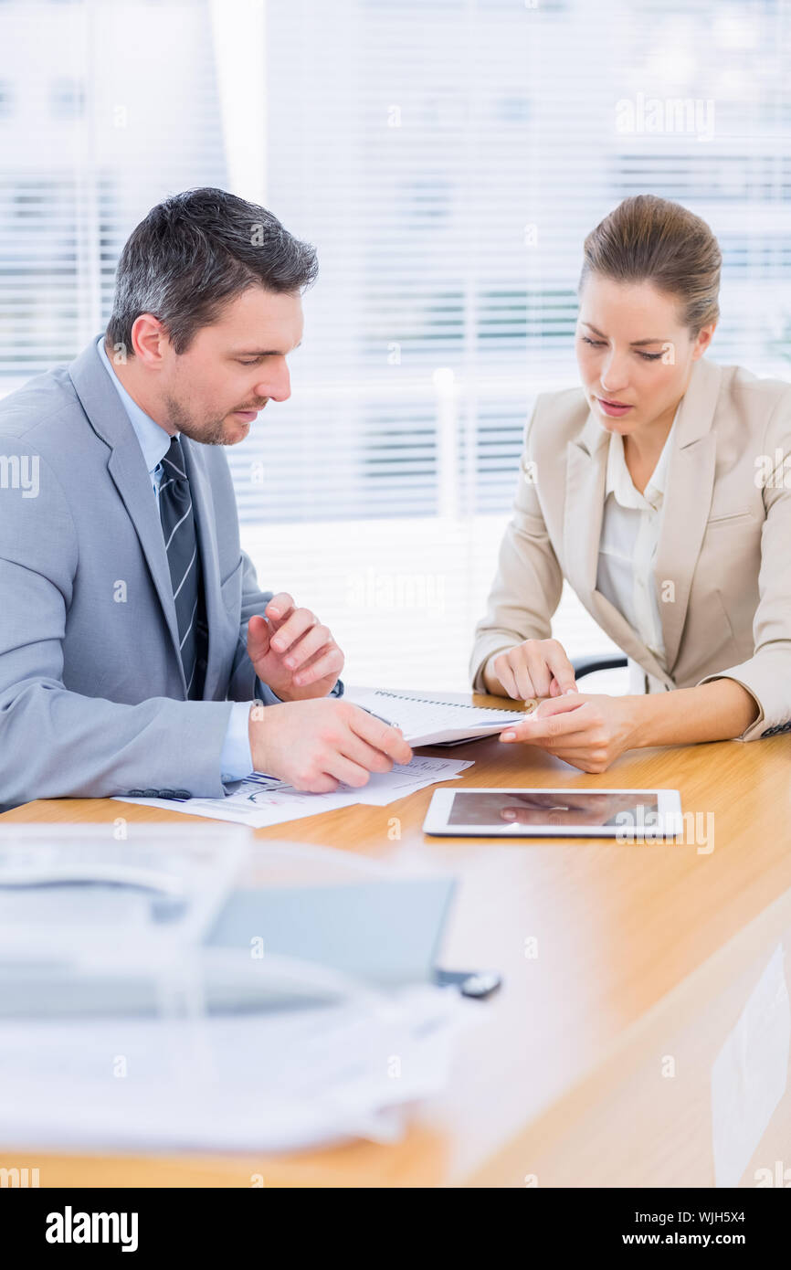 Smartly dressed young man and woman in a business meeting at office ...