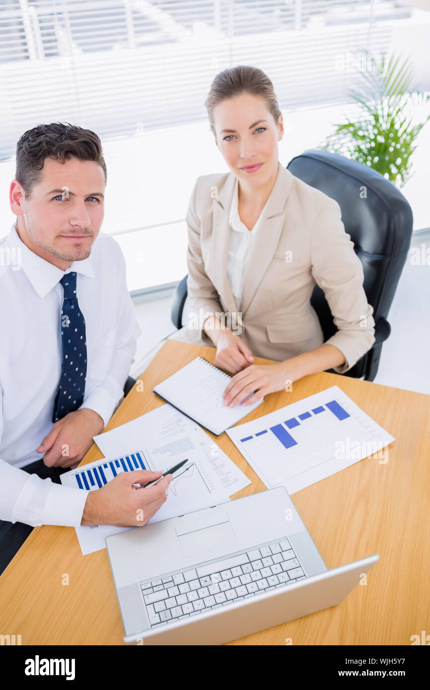 Smartly dressed young man and woman in a business meeting at office ...