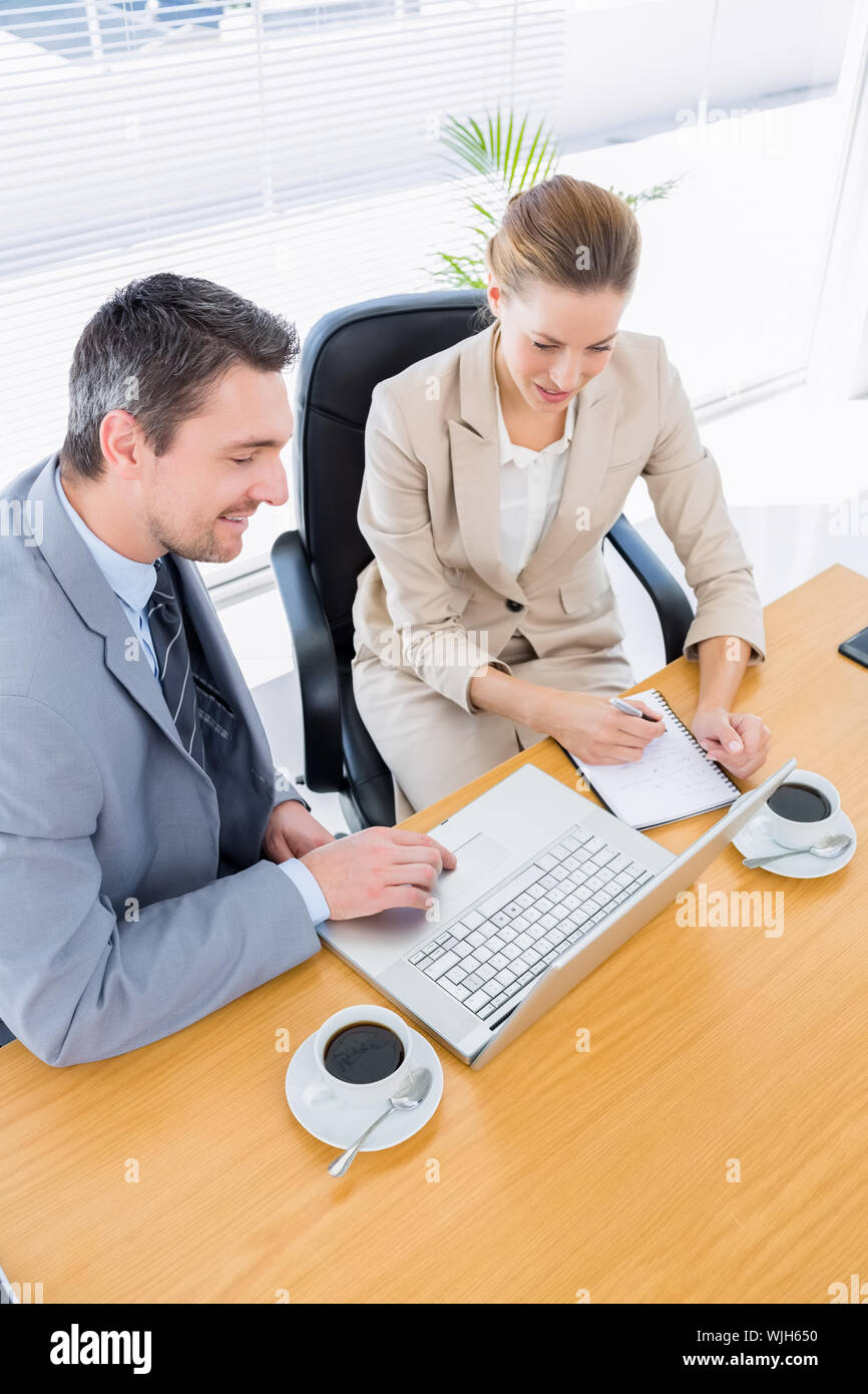 Smartly dressed young man and woman in a business meeting at office ...