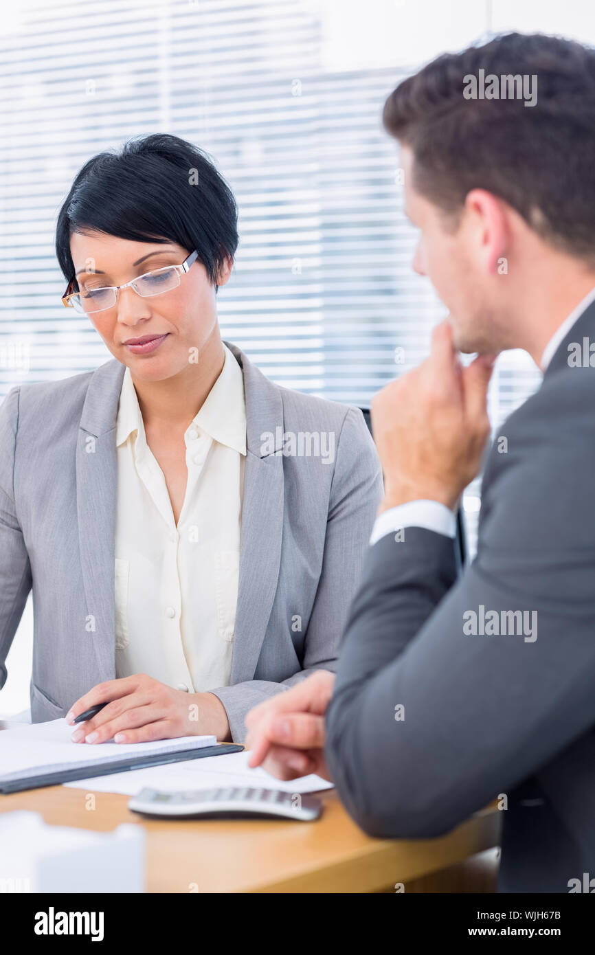 Smartly dressed young man and woman in a business meeting at office ...