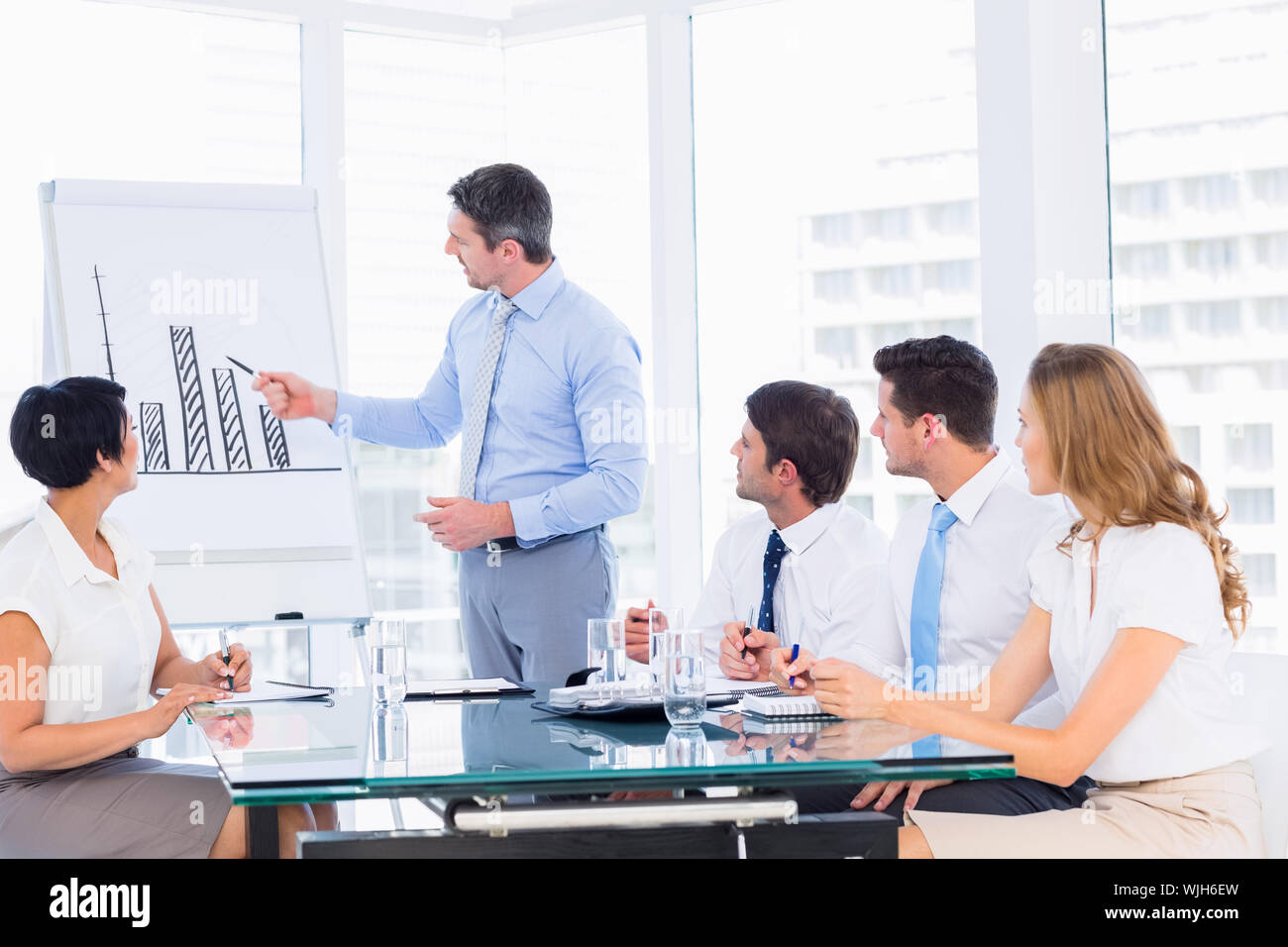 Businessman presenting new project to partners Stock Photo